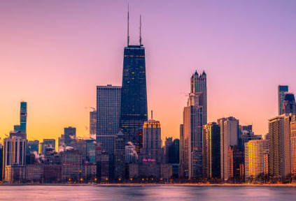 Chicago skyline. Skyscrapers span the horizon above the shore of Lake Michigan.
